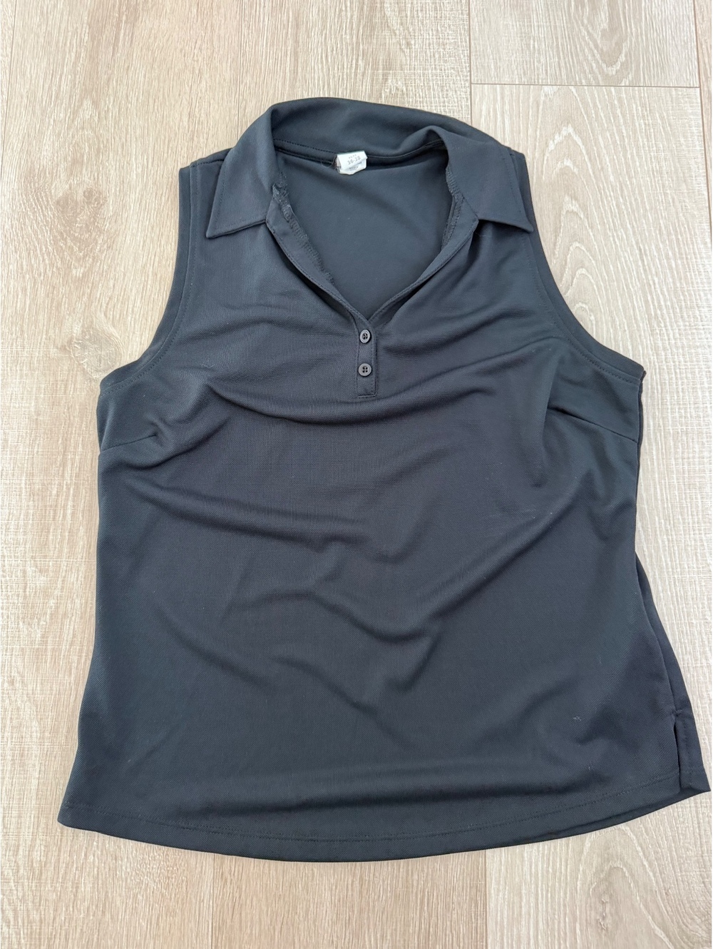 Marika black sleeveless 2 button polo top